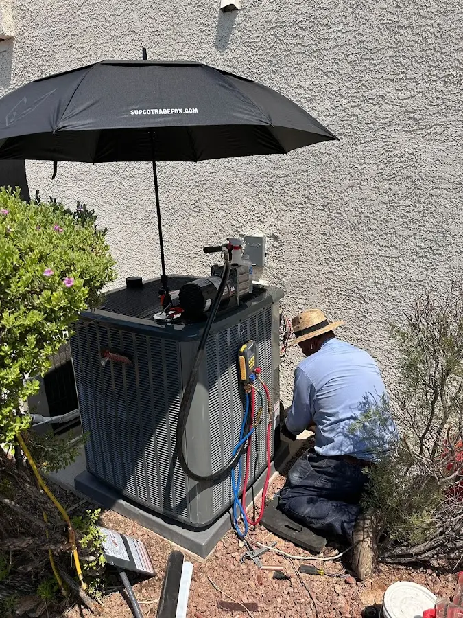 HVAC technician performing outdoor AC maintenance in Locust Grove
